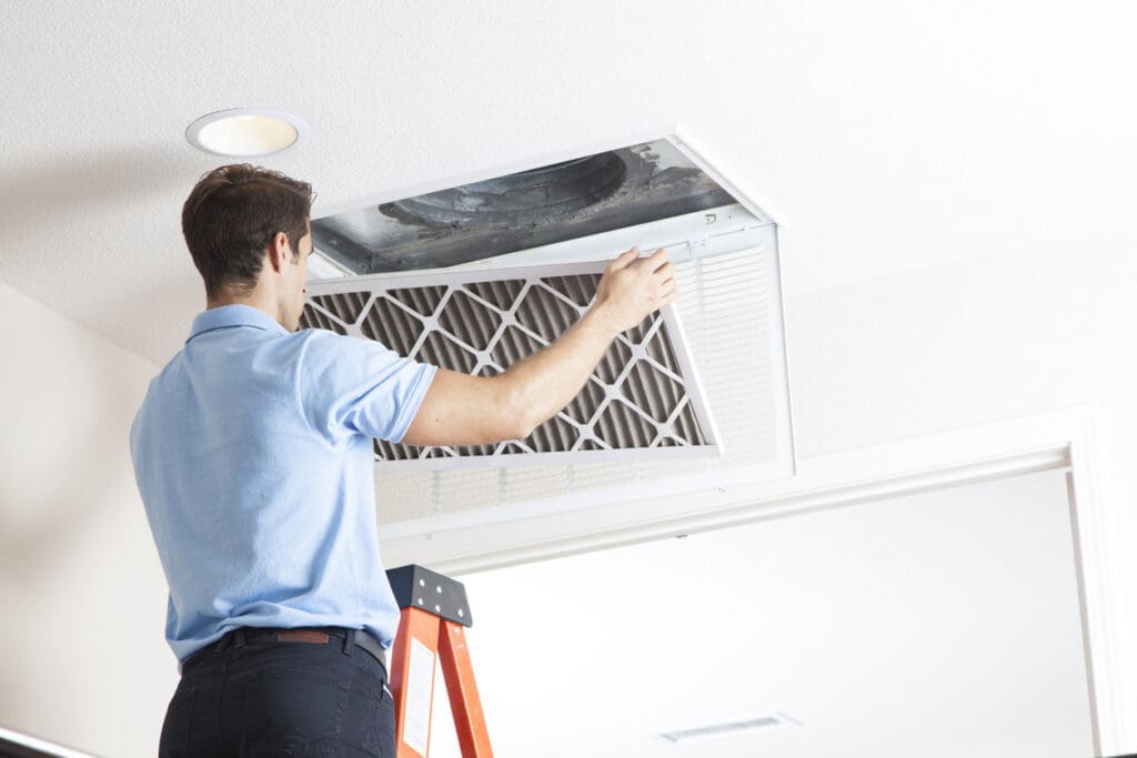 a technician repairing air ducts.